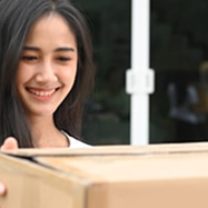 Woman holding a cardboard box with a blurred background